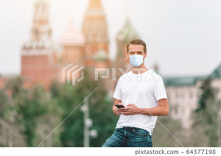 Happy young urban man in european city. 64377198