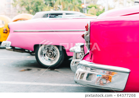 View of yellow classic vintage car in Old Havana, Cuba View of yellow classic vintage car in Old Havana, Cuba 64377208