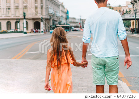 Tourist family in popular area in Havana, Cuba. 64377236