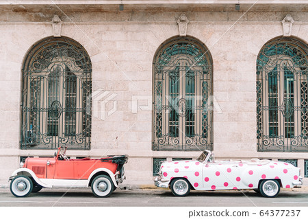 View of yellow classic vintage car in Old Havana, Cuba View of yellow classic vintage car in Old Havana, Cuba 64377237