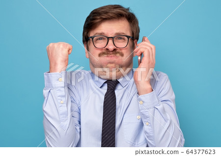 Pissed off angry mature guy with mustache in black 64377623