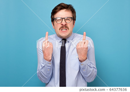 Fuck sign. Anger man showing fuck at camera. 64377636