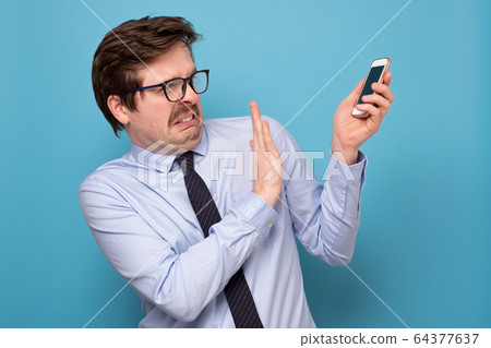 Frustrated mature man in shirt and tie holding Frustrated mature man in shirt and tie holding 64377637