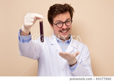 Scientist holding a glass tube with blue fluid 64377660