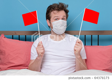 man with medical mask holding small empty flag man with medical mask holding small empty flag 64378173