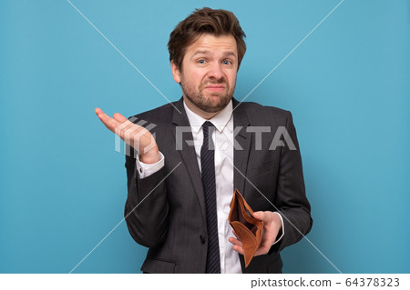 Unemployed sad caucasian man in suit showing empty 64378323