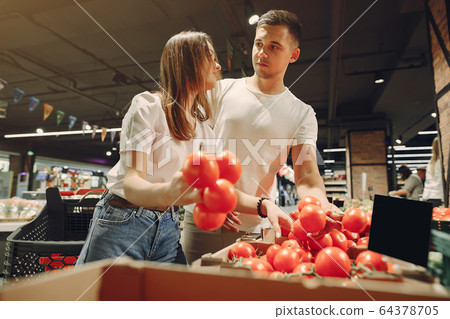 Young couple shoppong in supermarket Young couple shoppong in supermarket 64378705