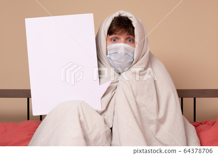 Caucasian young man in medical mask lying down in 64378706