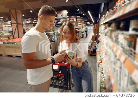 Young couple shoppong in supermarket Young couple shoppong in supermarket 64378720
