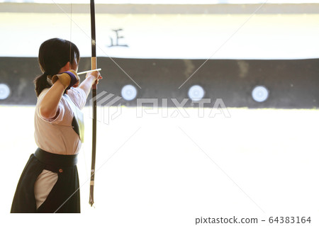 Young lady trying to target Young lady trying to target 64383164