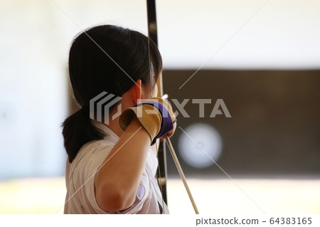 Young lady trying to target Young lady trying to target 64383165