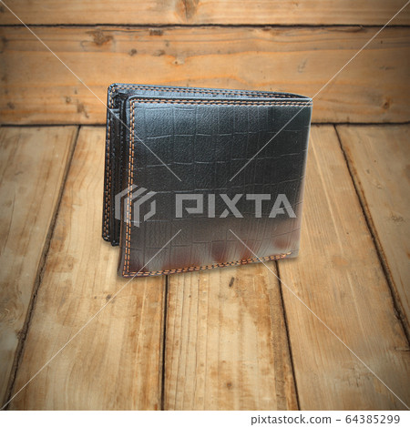 Black Leather Wallet on wooden background texture 64385299
