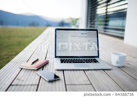 Working outdoors in home office, corona virus and quarantine concept. Working outdoors in home office, corona virus and quarantine concept. 64388736