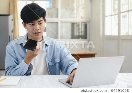 Young man talking with handfree on the phone. Young man talking with handfree on the phone. 64391098