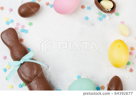 Chocolate easter rabbit and eggs on background 64392677