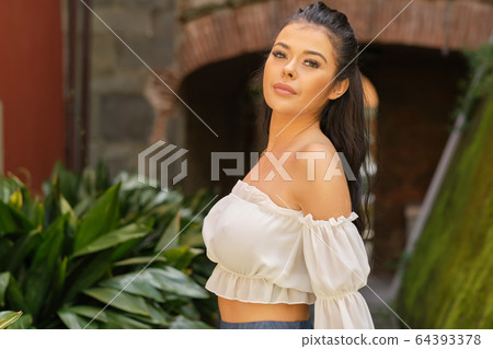 Portrait of smiling elegant tourist woman in long Portrait of smiling elegant tourist woman in long 64393378