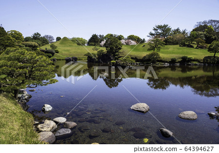 Scenery of cherry blossoms and Jojuen in Suizenji Park, a tourist destination in Kumamoto prefecture in spring Scenery of cherry blossoms and Jojuen in Suizenji Park, a tourist destination in Kumamoto prefecture in spring 64394627