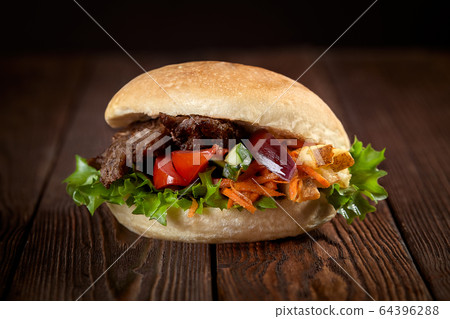 close up of kebab sandwich on wooden background 64396288