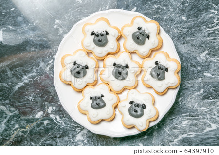 Eid Ad-Adha Mubarak holiday concept - cookies shaped like sheeps 64397910