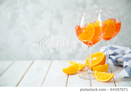 Aperol and ingredients drinks on wood background 64397971
