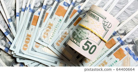 Top view of 50 rolled dollar bills on background 64400664