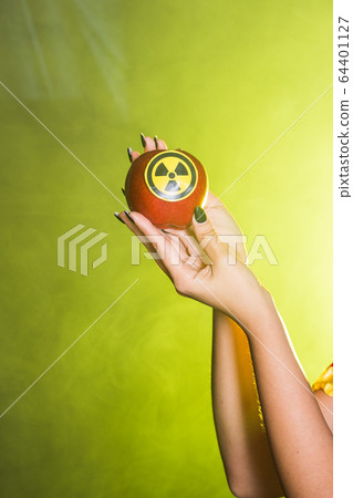 Woman dressed as fairytale character holds Radioactive atomic nuclear ionizing radiation danger warning symbol on apple. Nuclear and radiation measurement concept. Woman dressed as fairytale character holds Radioactive atomic nuclear ionizing radiation danger warning symbol on apple. Nuclear and radiation measurement concept. 64401127