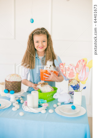 Cute girl with easter bunnies in the room decorative for the holiday. Easter mood 64401673