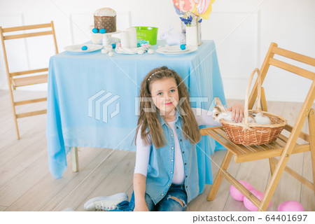 Cute girl with easter bunnies in the room decorative for the holiday. Easter mood 64401697