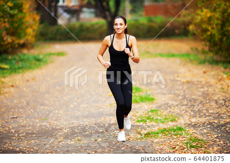Beautiful woman is engaged in fitness outdoors Beautiful woman is engaged in fitness outdoors 64401875