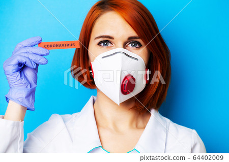 Woman in mask and protective gloves holding inscription coronavirus Woman in mask and protective gloves holding inscription coronavirus 64402009
