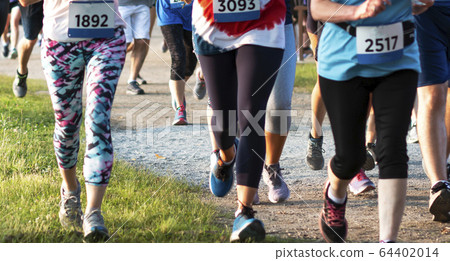Legs of runners wearing colorful spanded during Legs of runners wearing colorful spanded during 64402014