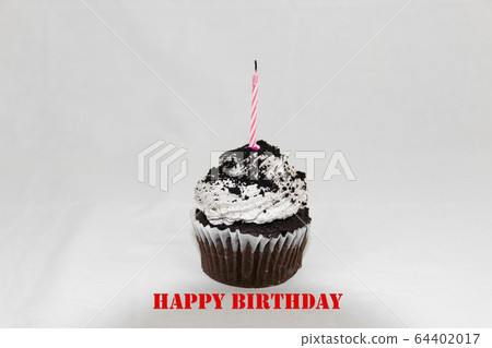 Cookies and cream cupcake with pink candle Cookies and cream cupcake with pink candle 64402017
