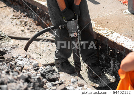Repair work on the city street. Professional 64402132