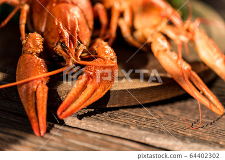 Boiled crayfish on rustic wooden background close-up 64402302