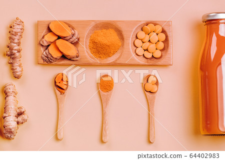 Turmeric in different conditions: fresh, dry root, pills, powder and cut plant. Turmeric in different conditions: fresh, dry root, pills, powder and cut plant. 64402983