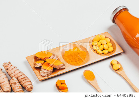 Turmeric in different conditions: fresh, dry root, pills, powder and cut plant. Turmeric in different conditions: fresh, dry root, pills, powder and cut plant. 64402985