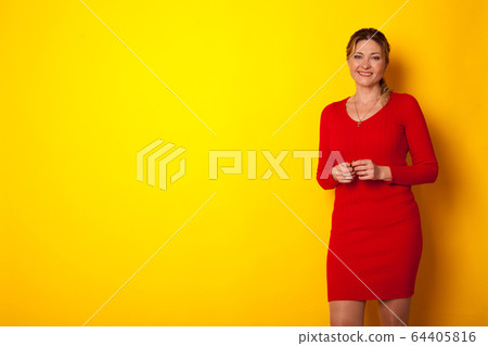 portrait of a beautiful woman of forty years in a red dress 64405816