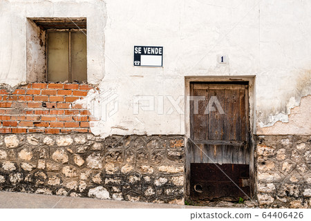 Old abandoned village house with a "for sale" sign on the front Old abandoned village house with a "for sale" sign on the front 64406426