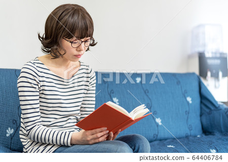 Woman reading at home 64406784
