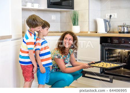 Kids and mother baking. Two children and parent Kids and mother baking. Two children and parent 64406995