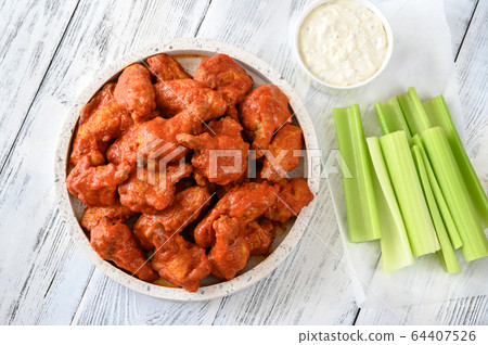 Bowl of buffalo wings with blue cheese dip Bowl of buffalo wings with blue cheese dip 64407526