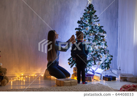 Mom and son Christmas tree Christmas tree gifts lights garlands Mom and son Christmas tree Christmas tree gifts lights garlands 64408033