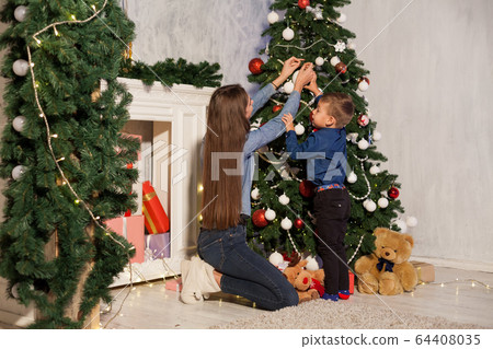 Mom and son Christmas tree Christmas tree gifts lights garlands Mom and son Christmas tree Christmas tree gifts lights garlands 64408035