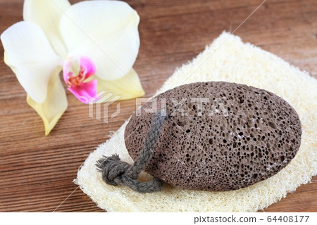 Volcanic pumice stone on the  washcloth  in rustic 64408177