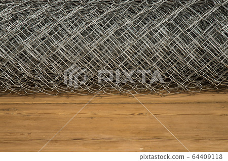 Rabitz grid in a roll on a wooden background 64409118