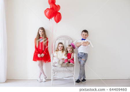 Kids friends boy and girl with red balloons on holiday Kids friends boy and girl with red balloons on holiday 64409460