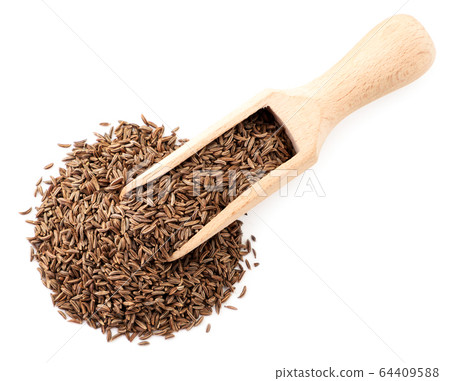 Cumin seeds in a wooden spoon on a white. The view Cumin seeds in a wooden spoon on a white. The view 64409588