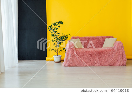 pink sofa in the interior of the room with a yellow background 64410018