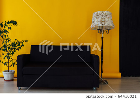 black office sofa in the interior of the room with a yellow background 64410021