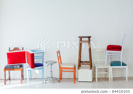 lots of different chairs in the interior of the white room 64410103